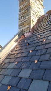 Copper snow hooks on a slate roof