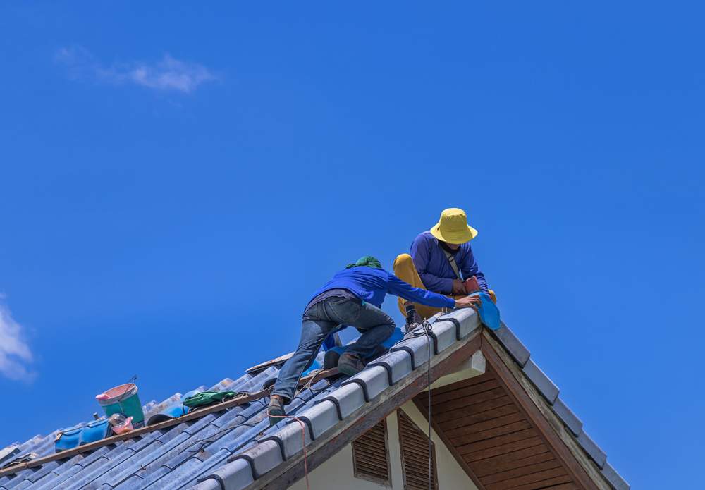 worker repairing roof