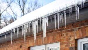 Icicles hanging from a roof edge in winter